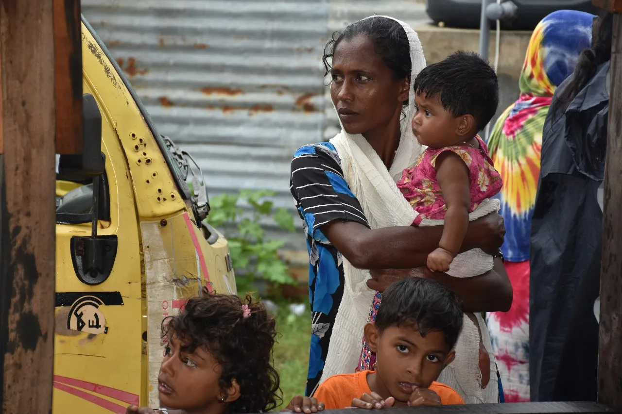 Mother holding child in community setting